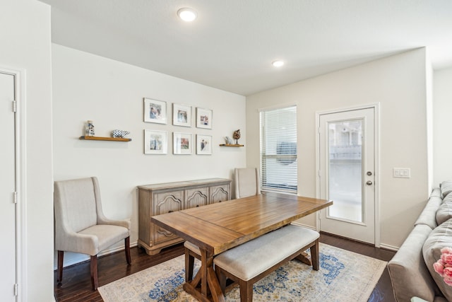 dining room featuring plenty of natural light and dark hardwood / wood-style floors