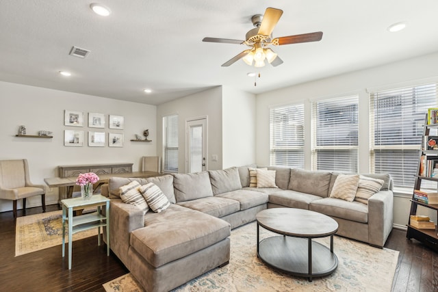 living room featuring dark hardwood / wood-style flooring and ceiling fan