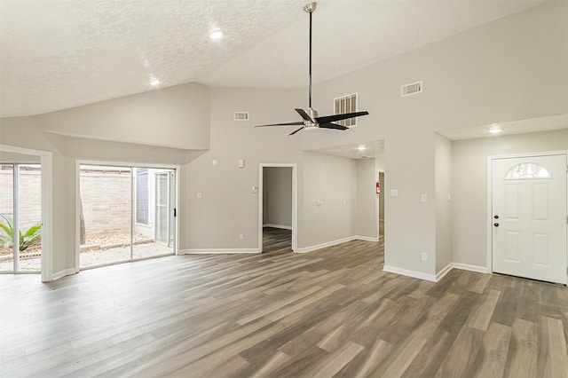 unfurnished living room featuring ceiling fan, wood-type flooring, a textured ceiling, and high vaulted ceiling