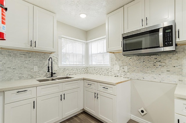 kitchen featuring white cabinetry, sink, and decorative backsplash