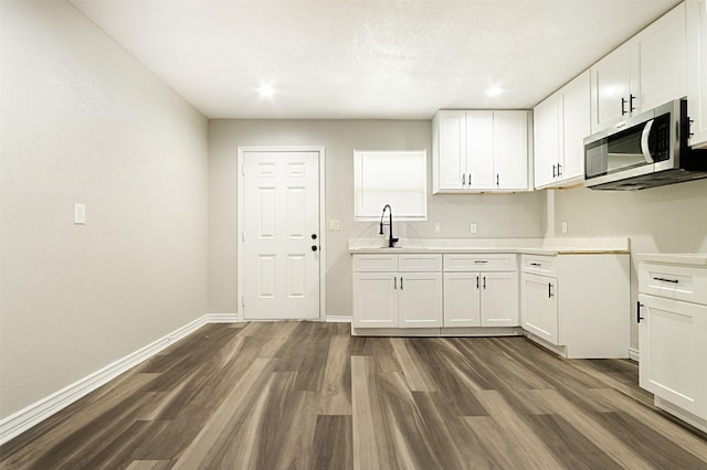 kitchen featuring sink, white cabinets, and dark hardwood / wood-style floors