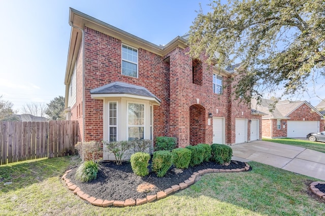 view of front of property featuring a garage and a front lawn