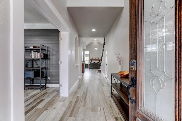 entryway featuring light hardwood / wood-style flooring and lofted ceiling