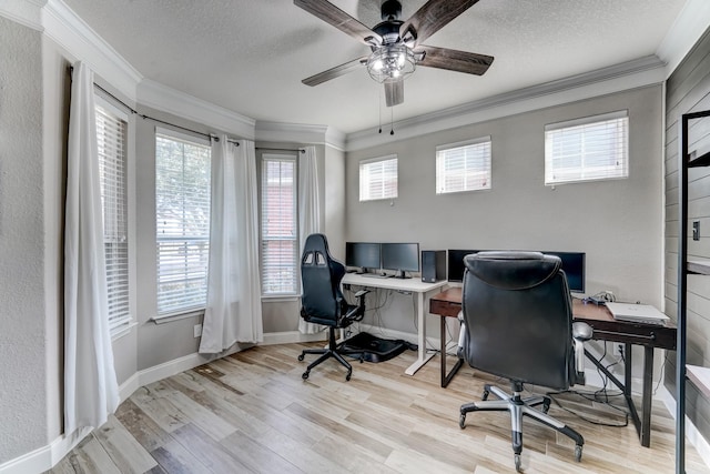 office area with a textured ceiling, ceiling fan, light wood-type flooring, and crown molding