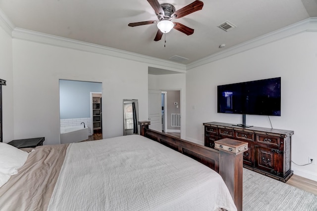 bedroom featuring a walk in closet, ceiling fan, crown molding, and light hardwood / wood-style flooring