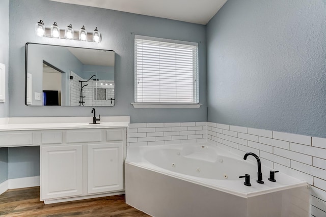 bathroom with separate shower and tub, hardwood / wood-style floors, and vanity