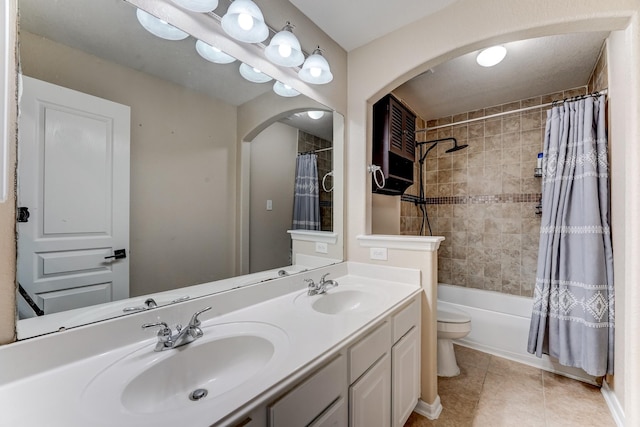 full bathroom with tile patterned floors, vanity, toilet, and shower / bath combo with shower curtain