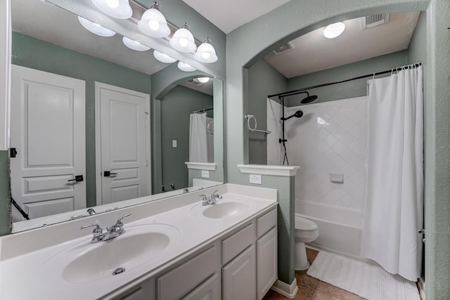 full bathroom featuring tile patterned flooring, vanity, shower / bath combination with curtain, and toilet