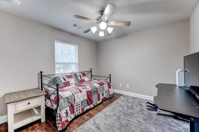 bedroom with ceiling fan and dark hardwood / wood-style flooring