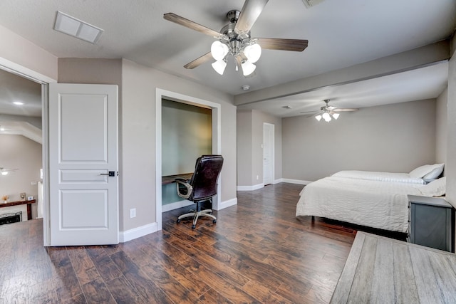 bedroom with dark hardwood / wood-style flooring and ceiling fan