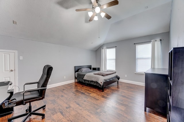 bedroom with ceiling fan, dark hardwood / wood-style floors, and vaulted ceiling