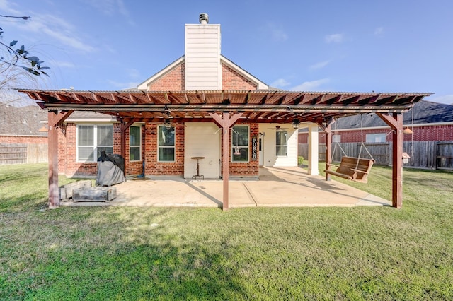 back of house featuring ceiling fan, a yard, and a pergola