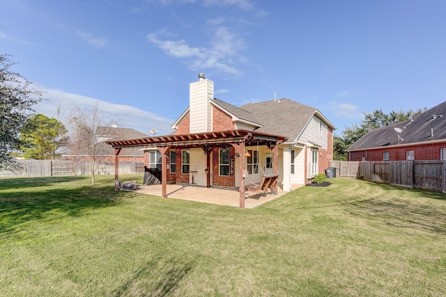 back of house featuring a patio and a lawn