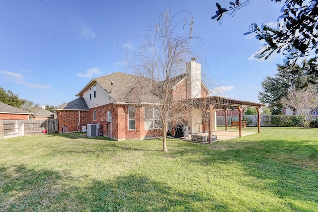 back of property with a lawn, a patio area, and central AC unit