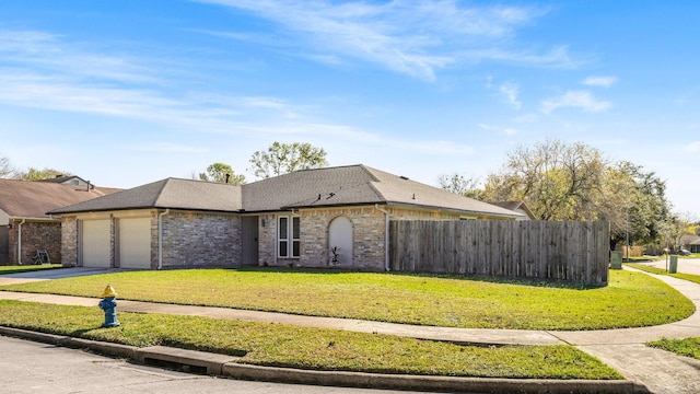 ranch-style home featuring a garage and a front yard