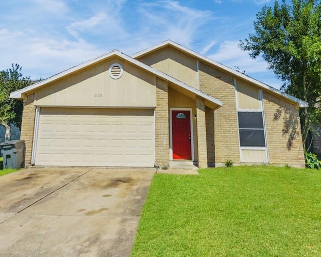 view of front of property with a garage and a front lawn