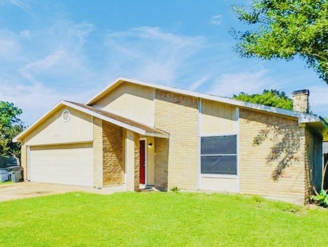 view of front of property featuring a garage and a front lawn