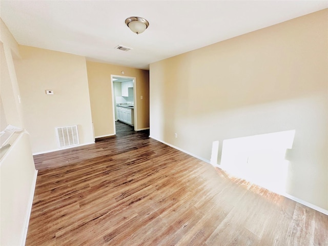 empty room with hardwood / wood-style flooring