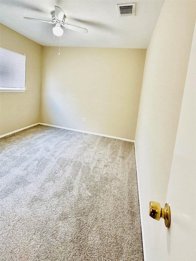 empty room featuring carpet flooring and ceiling fan