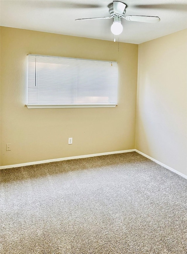 carpeted spare room with ceiling fan