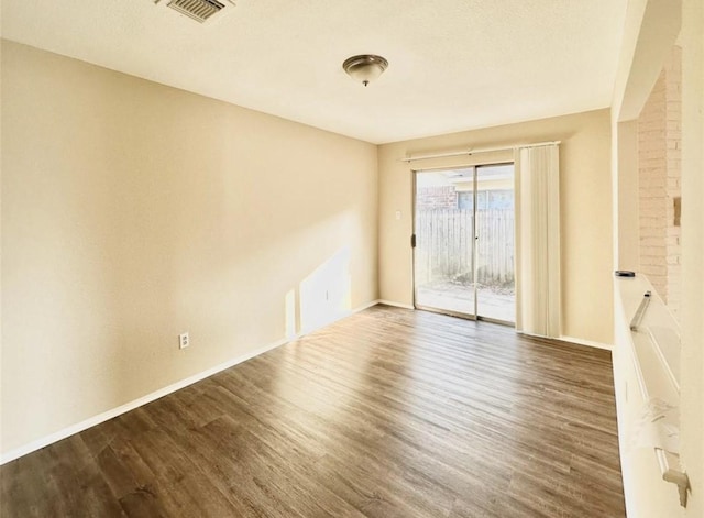 spare room featuring dark hardwood / wood-style floors