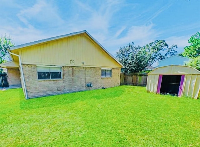 rear view of house with an outbuilding and a lawn