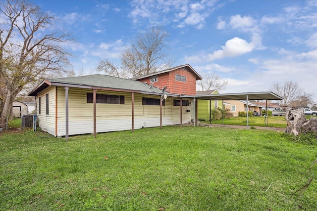 rear view of house with a carport and a lawn