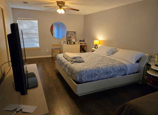 bedroom with dark hardwood / wood-style floors and ceiling fan