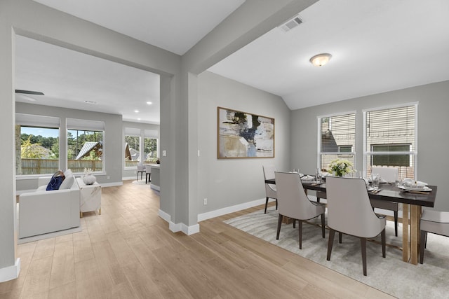 dining area with light hardwood / wood-style flooring and lofted ceiling