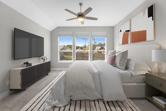 bedroom with ceiling fan, carpet floors, and lofted ceiling