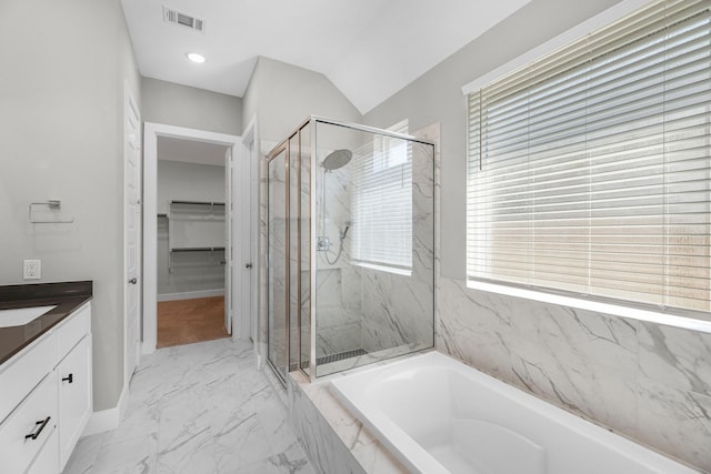 bathroom with shower with separate bathtub, vanity, and vaulted ceiling