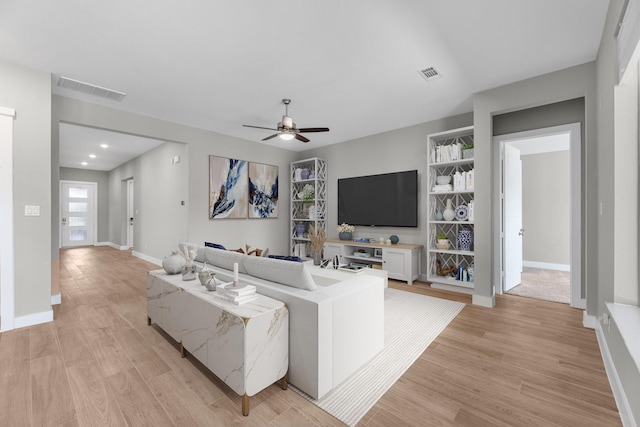 living room with ceiling fan and light hardwood / wood-style floors