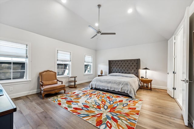 bedroom featuring ceiling fan, lofted ceiling, and light wood-type flooring