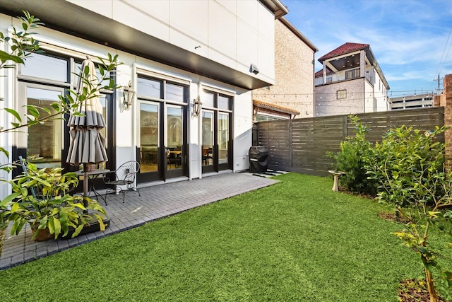 rear view of house featuring a yard and a patio