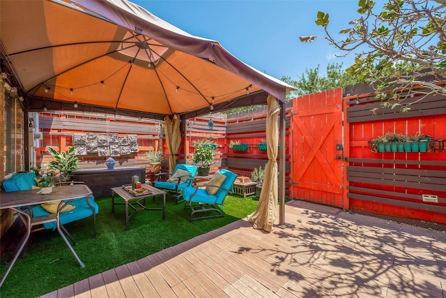 wooden terrace featuring a gazebo and a yard