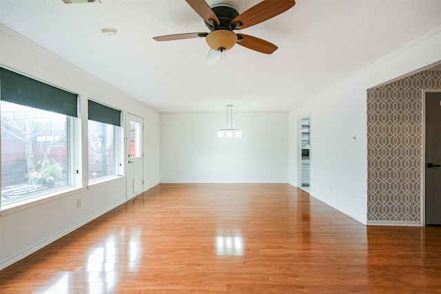 unfurnished room featuring ceiling fan, crown molding, and light hardwood / wood-style flooring