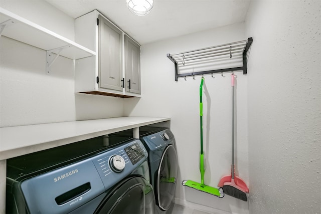 laundry area with cabinets and washing machine and dryer