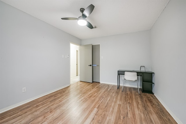 unfurnished office featuring light hardwood / wood-style floors and ceiling fan