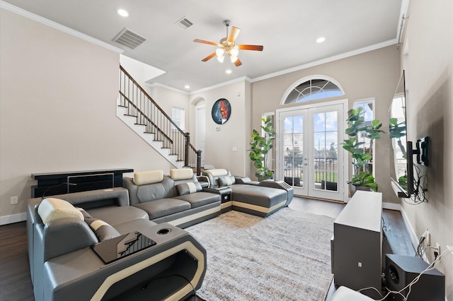 living room with ceiling fan, ornamental molding, dark wood-type flooring, and french doors