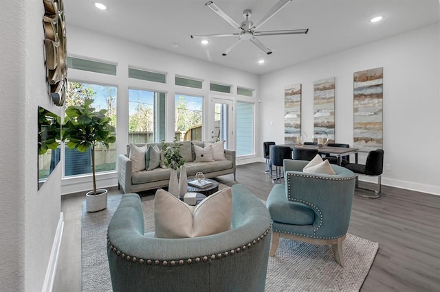 living room with hardwood / wood-style floors, a wealth of natural light, and ceiling fan