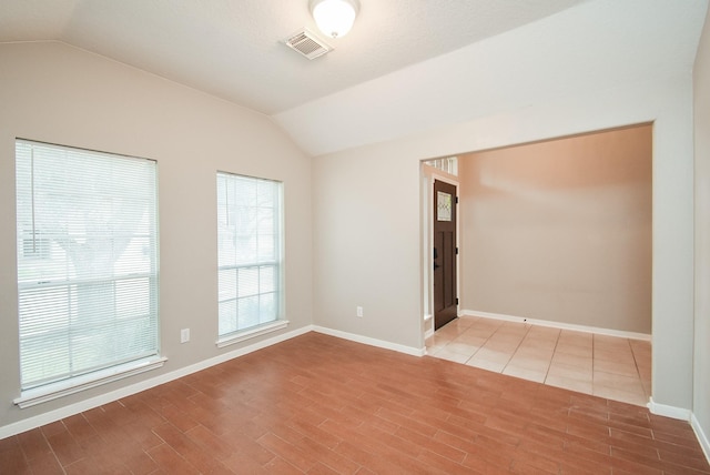 empty room with vaulted ceiling