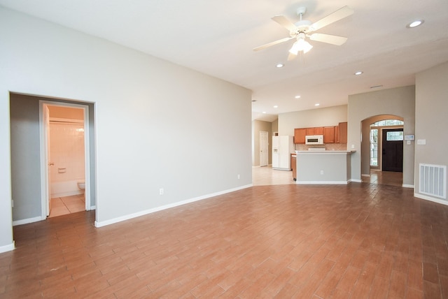 unfurnished living room with ceiling fan and light wood-type flooring