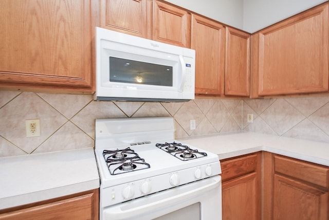 kitchen with white appliances and tasteful backsplash