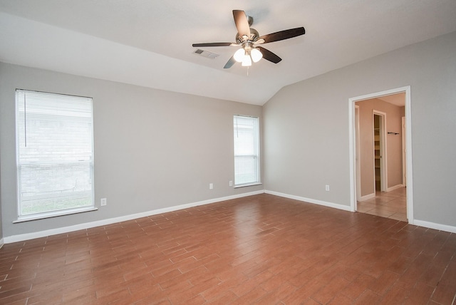 spare room with hardwood / wood-style floors, ceiling fan, and lofted ceiling