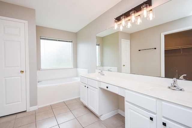 bathroom featuring tile patterned flooring, vanity, and a washtub