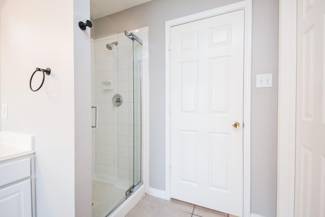 bathroom with tile patterned flooring, vanity, and a shower with shower door