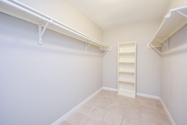 walk in closet with light tile patterned floors