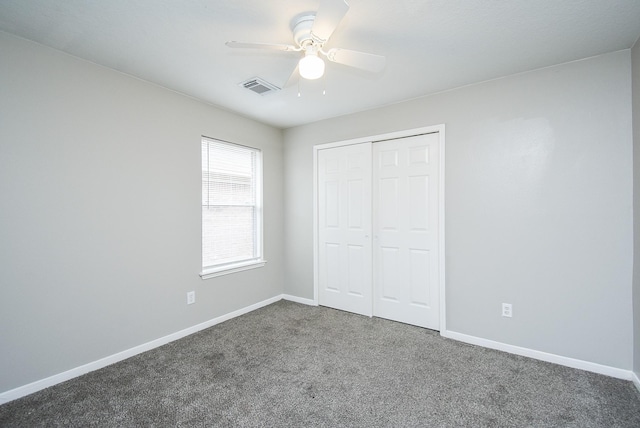 unfurnished bedroom with carpet flooring, a closet, and ceiling fan