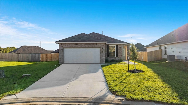 single story home with central AC unit, a front lawn, and a garage