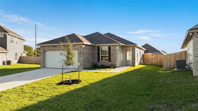 ranch-style home with central air condition unit, a front yard, and a garage